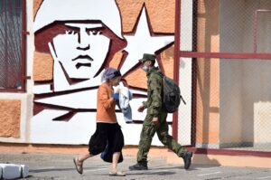 A soldier and a woman walk past the headquarters of the Operative Group of the Russian Troops in the town of Tiraspol, the capital of Transnistria, Sept. 11, 2021. (AFP Photo)