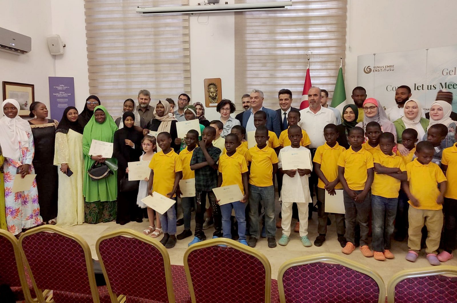 Students hold their certificates, symbolizing their success in the Turkish language course, during a ceremony at a Yunus Emre Institute (YEE) center, Abuja, Nigeria, Feb. 27, 2024. (AA Photo)