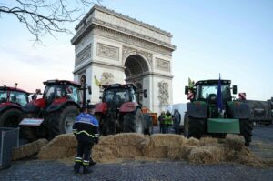 Police officers look at tractors parked next to the Arc de Triomphe on Champs-Elysees during a protest by the French farmers' union, Paris, France, March 1, 2024. (AFP Photo)