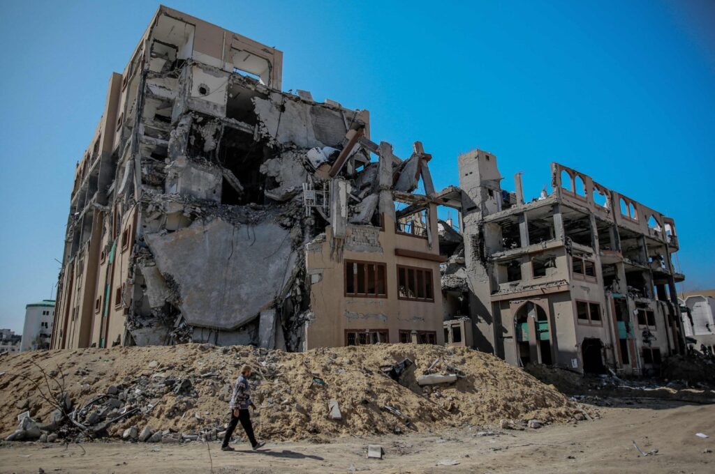 A Palestinian man walks past a heavily damaged building of Islamic University after an Israeli attack, Gaza City, Palestine, Feb. 15, 2024. (AFP Photo)