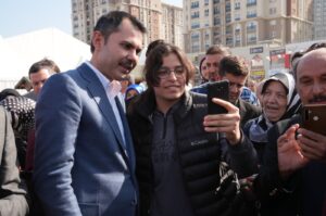People take a selfie with Murat Kurum (L) in the Başakşehir district, Istanbul, Türkiye, Feb. 29, 2024. (İHA Photo)