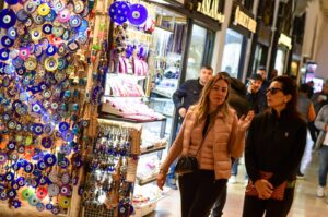 Two women walk past a souvenir shop at the Grand Bazaar in Istanbul, Türkiye, Feb. 28, 2024. (Reuters Photo)