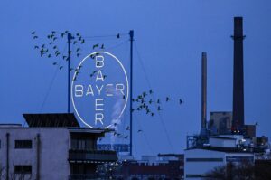 A flock of birds fly past the logo of German chemical and pharmaceutical giant Bayer above the group's plant, Leverkusen, Germany, March 4, 2024. (AFP Photo)