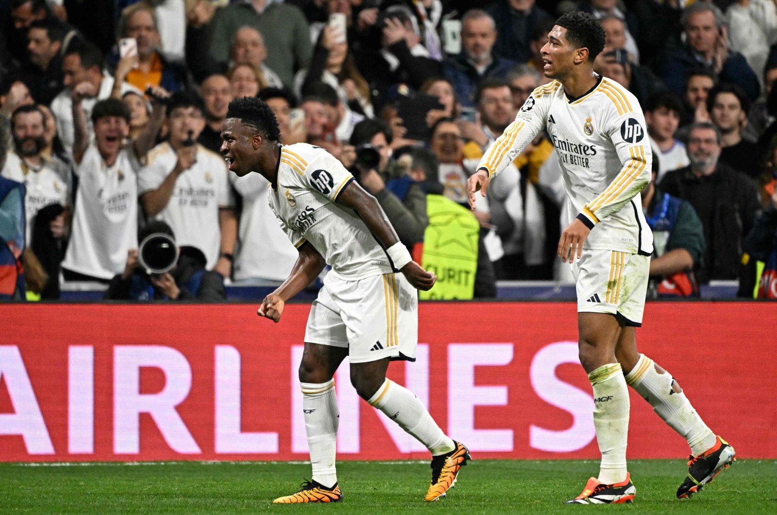 Real Madrid's Vinicius Junior (L) celebrates scoring the opening goal, with Jude Bellingham, during the UEFA Champions League last 16 second leg football match against RB Leipzig at the Santiago Bernabeu stadium, Madrid, Spain, March 6, 2024. (AFP Photo)
