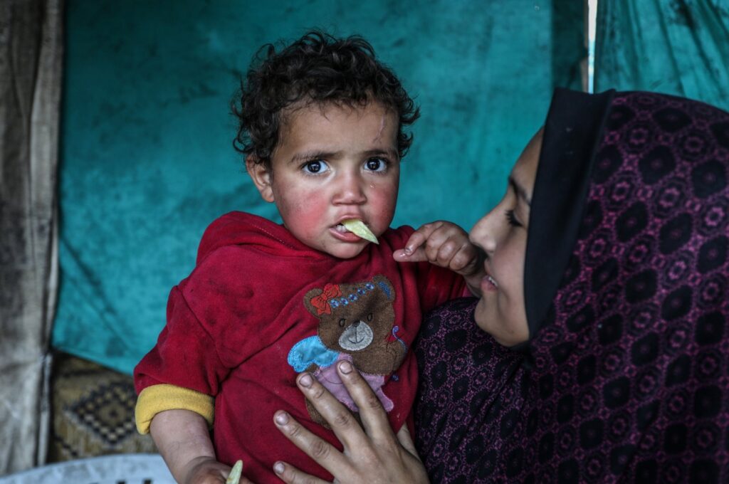 A Palest woman and her child are seen at a refugee camp in Khan Younis, Gaza, Palestine, March 7, 2024. (AA Photo)