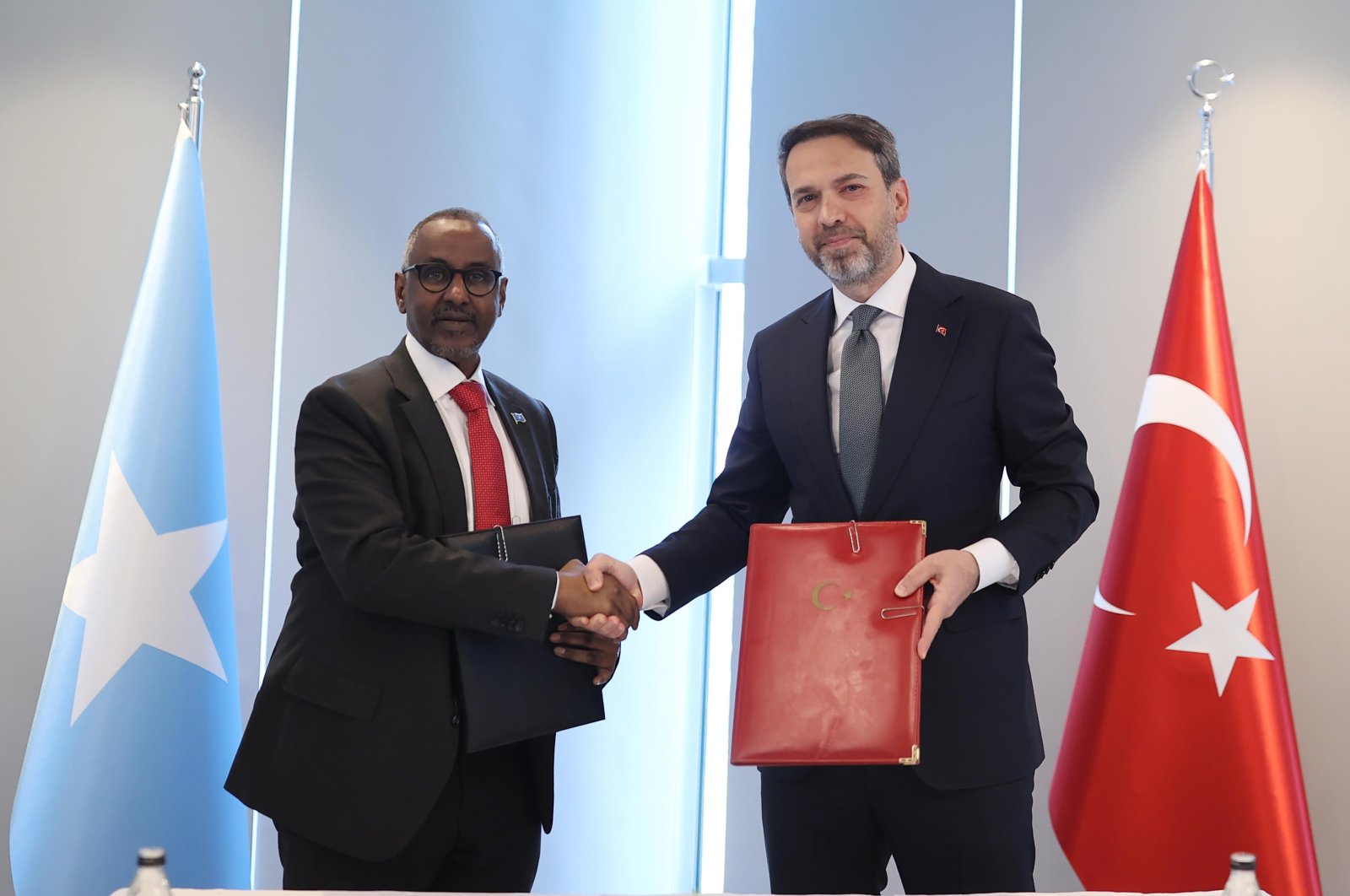 Energy Minister Alparslan Bayraktar shakes hands with Somalia's Petroleum and Mineral Resources Minister Abdirizak Omar Mohamed, Ankara, Türkiye, March 7, 2024. (DHA Photo)