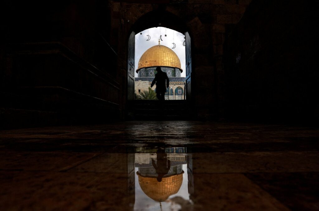 A man walks by the entrance to the Al-Aqsa Mosque, also known to Jews as the Temple Mount, amid the ongoing Israel-Palestine conflict, the Old City, occupied East Jerusalem, Palestine, March 7, 2024. (Reuters Photo)