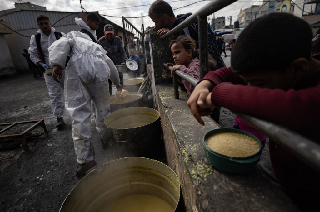 Internally displaced Palestinians hold empty bowls as they line up to receive food aid provided by a Palestinian youth group in the Rafah refugee camp, Gaza Strip, Palestine, March 7, 2024. (EPA Photo)