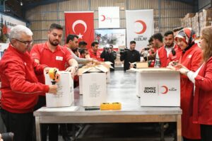 Turkish Red Crescent staff seal aid boxes at the launch of a Ramadan campaign, Hatay, southern Türkiye, March 8, 2024. (AA Photo)
