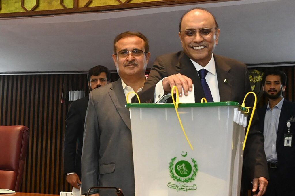 This handout photograph taken and released by the Pakistan National Assembly on March 9, 2024 shows presidential candidate and the leader of Pakistan Peoples Party (PPP) Asif Ali Zardari (2R) casting his ballot to vote during the presidential election at the Parliament House in Islamabad. (Pakistan National Assembly via AFP)