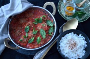Mint leaves and chunky tomato sauce add a fresh touch to these bulgur meatballs. (dpa Photo)