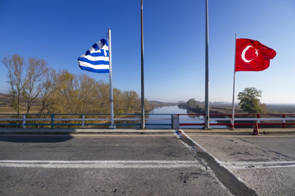 An undated photo shows Greek and Turkish flags on the border over Meriç (Evros) River. (Shutterstock Photo)