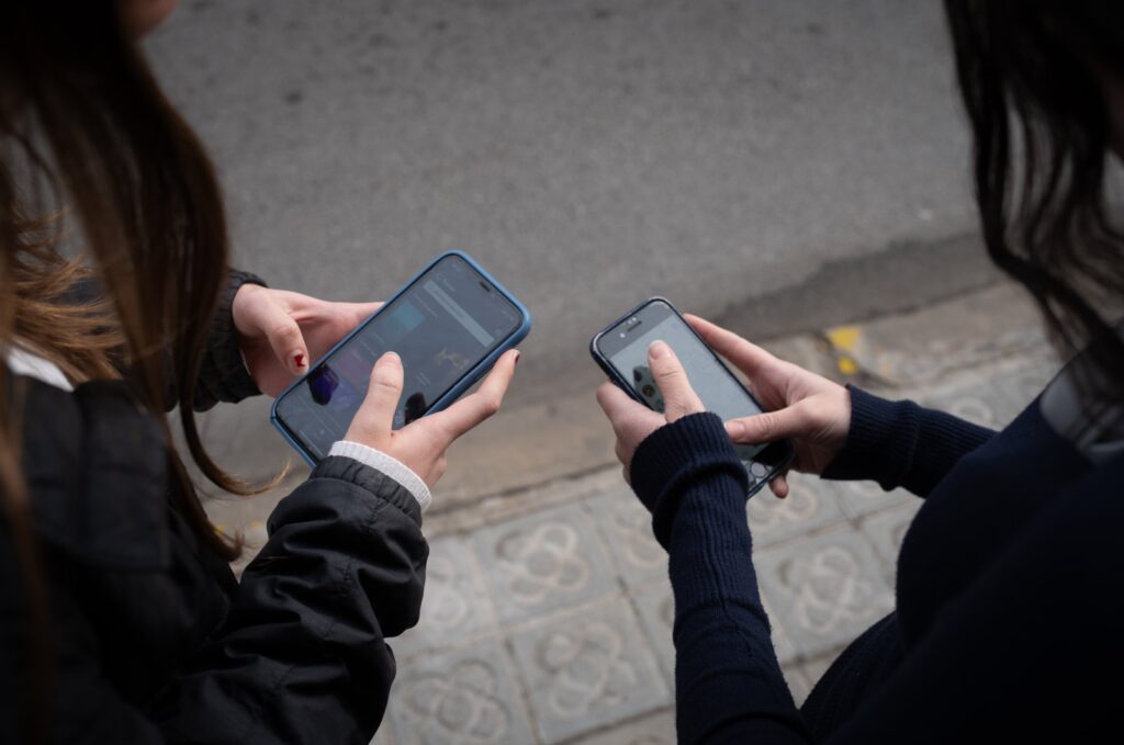Two people use cell phones in Barcelona, Catalonia, Spain, Feb. 1, 2024. (Reuters File Photo)