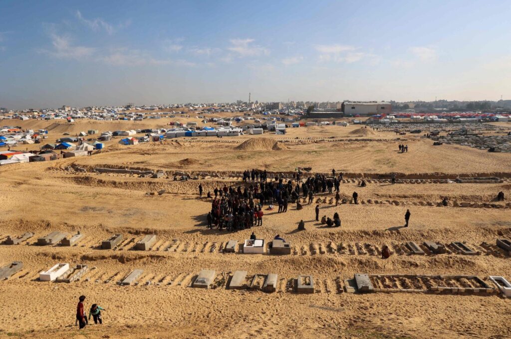 Palestinians bury their dead who were killed during overnight Israeli strikes, at a cemetery in Rafah, in the southern Gaza Strip on Feb. 21, 2024. (AFP File Photo)