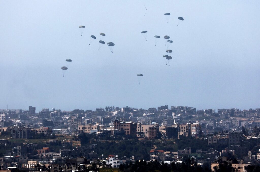 This picture taken from Israel's southern border with the Gaza Strip shows humanitarian aid being airdropped over the Palestinian territory on March 13, 2024. (AFP Photo)