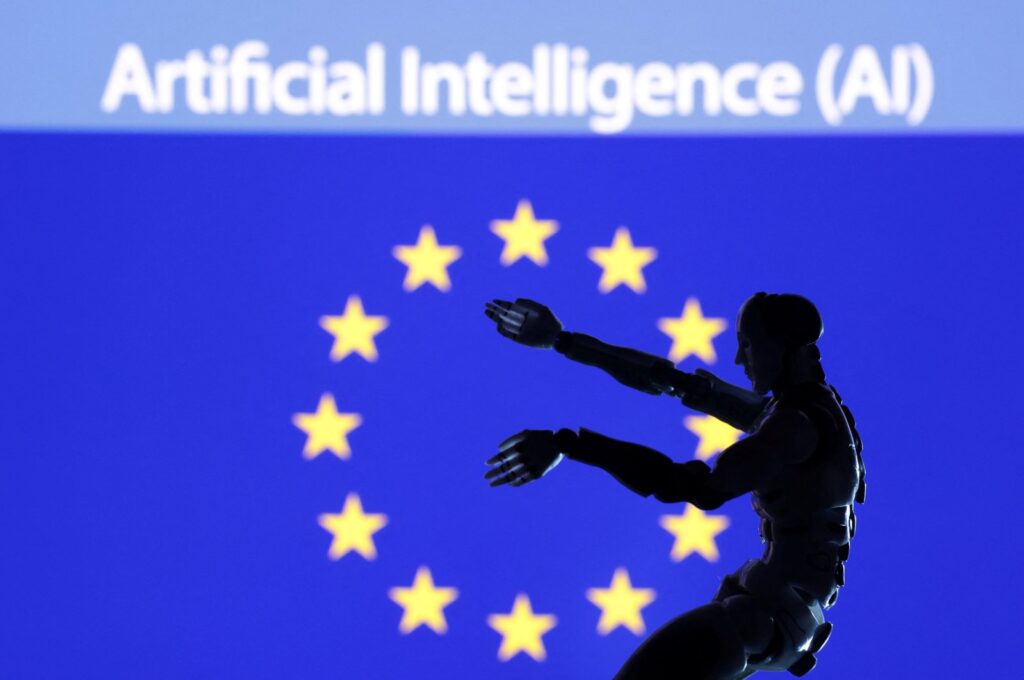 The words "Artificial intelligence (AI)," a miniature robot and the EU flag are seen in this illustration taken Dec. 21, 2023. (Reuters Photo)
