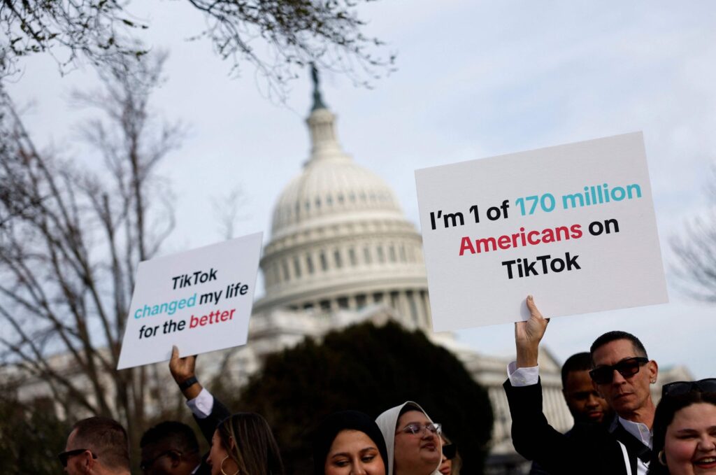 Participants hold signs in support of TikTok outside the U.S. Capitol Building in Washington, D.C. on March 13, 2024. (AFP Photo)