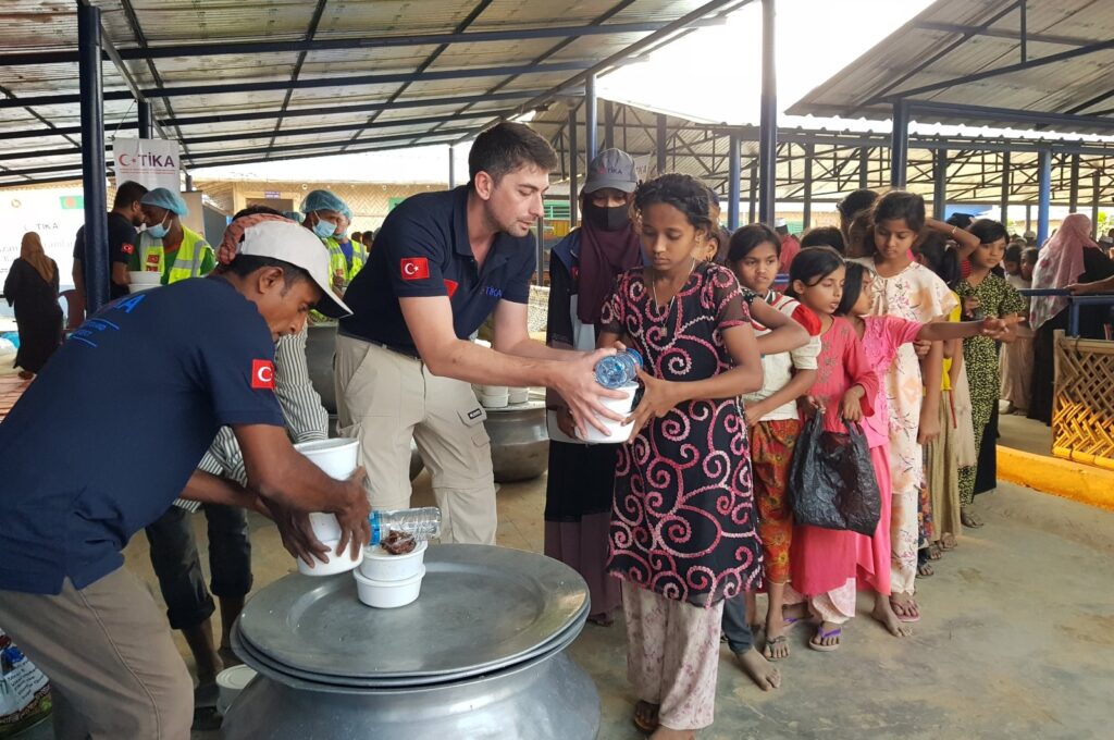 Staff of the Turkish Cooperation and Coordination Agency (TIKA) provide food as part of the iftar program for refugees in Cox's Bazar, Bangladesh, March 13, 2024. (AA Photo)