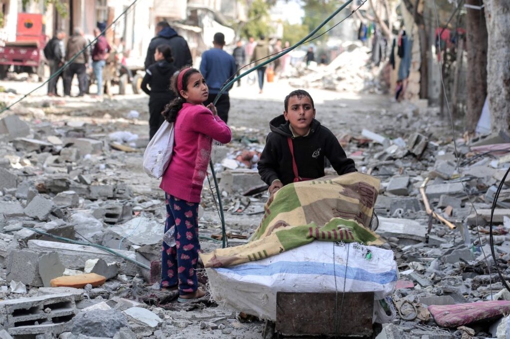 Palestinian children salvage some items found amid the destruction caused by Israeli bombing in Bureij in the central Gaza Strip on March 14, 2024. (AFP Photo)