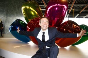 Artist Jeff Koons in front of the sculpture "Tulips" at the presentation of his solo exhibition titled "Jeff Koons. Celebration," Neue Nationalgalerie, Berlin, Germany, Oct. 29, 2008. (Shutterstock Photo)