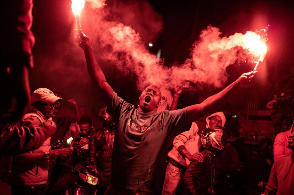 A supporter of Senegalese opposition leader Ousmane Sonko and presidential candidate Bassirou Diomaye Faye celebrates after the two men were released from prison, in Dakar, Senegal, March 14, 2024. (AFP Photo)