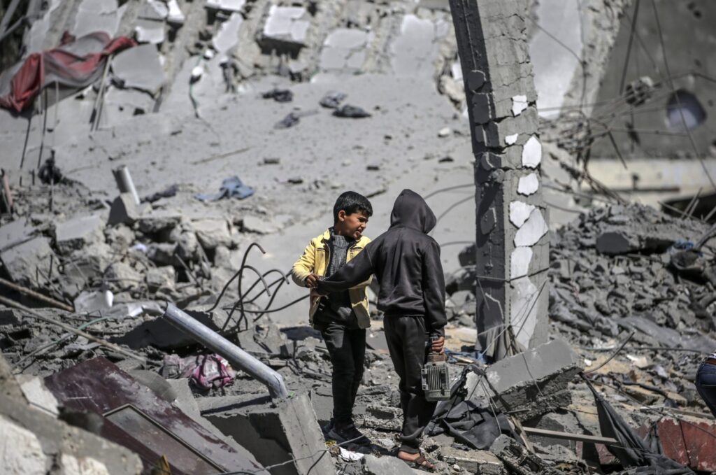 Palestinian children stand in the rubble of a destroyed house following an Israeli airstrike in Deir Al Balah town southern Gaza Strip, March 13, 2024. (EPA Photo)