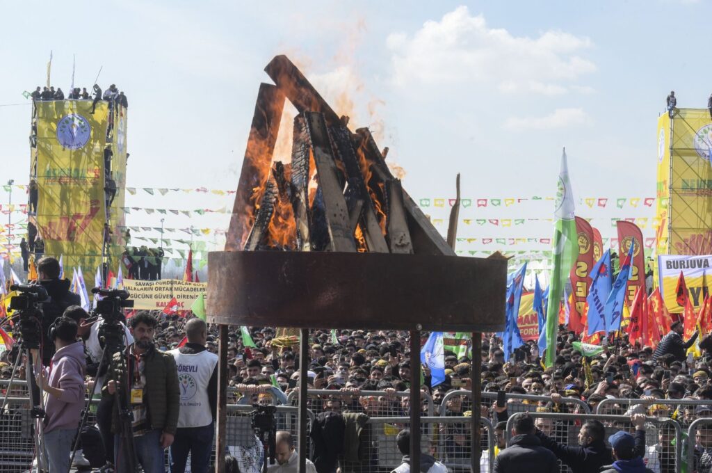 A lit bonfire is seen in the midst of crowds gathering for Nevruz celebrations in Istanbul, Türkiye, March 17, 2024. (AA Photo)