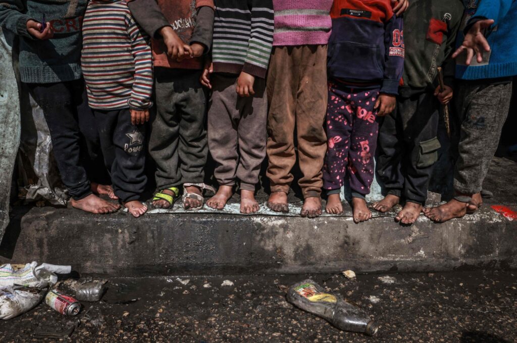 Displaced Palestinian children stand in front of makeshift tents at a roadside camp in Rafah, southern Gaza, Palestine, March 13, 2024. (AFP Photo)