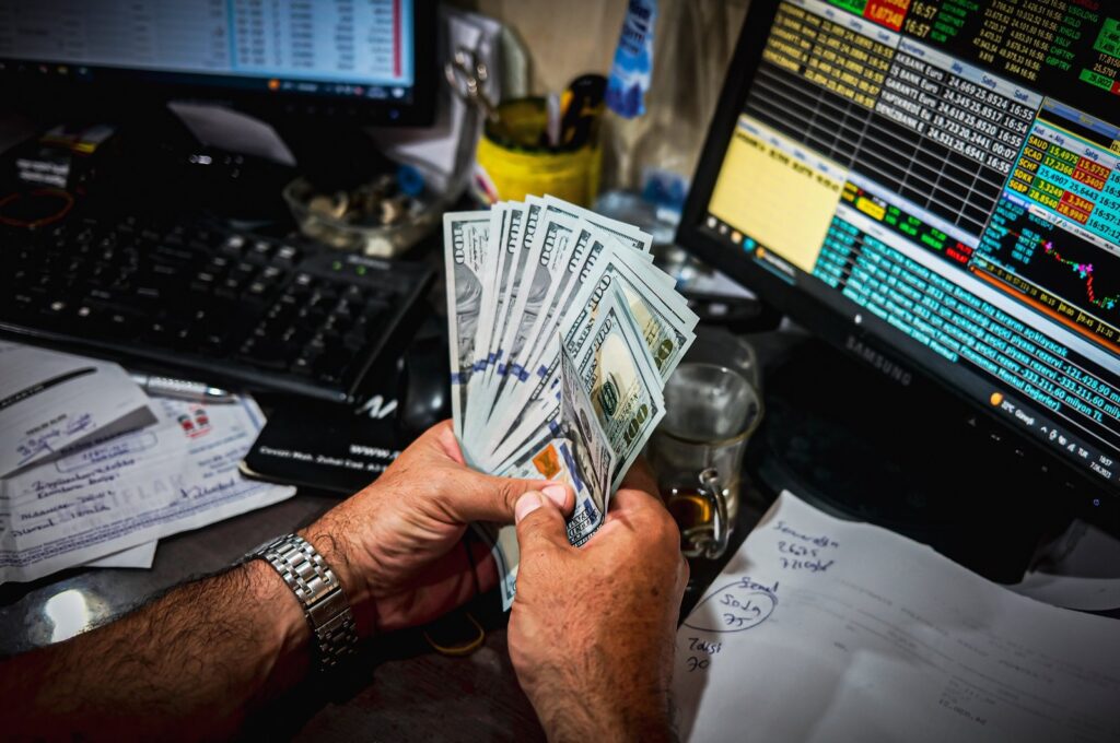 A person holds dollar banknotes in an exchange office in Izmir, western Türkiye, June 7, 2023. (Reuters Photo)