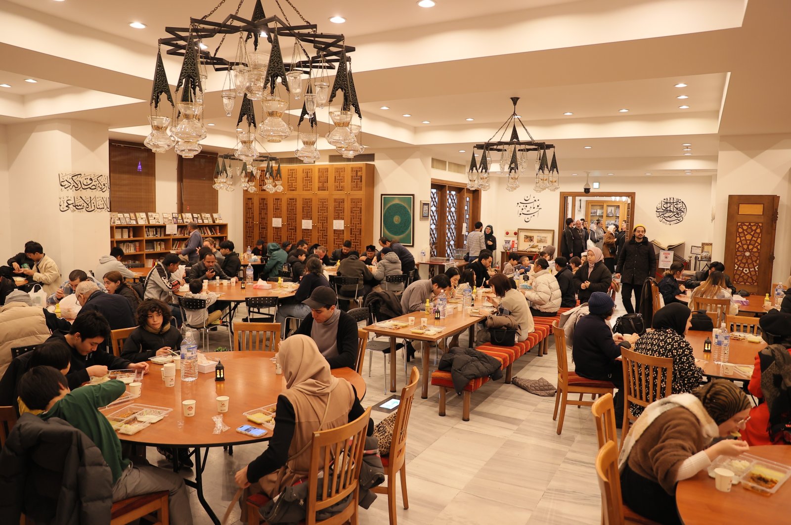 Japanese Muslims and non-Muslims break the fast at the traditional iftar program at Tokyo Mosque, Tokyo, Japan, March 18, 2024. (IHA Photo)