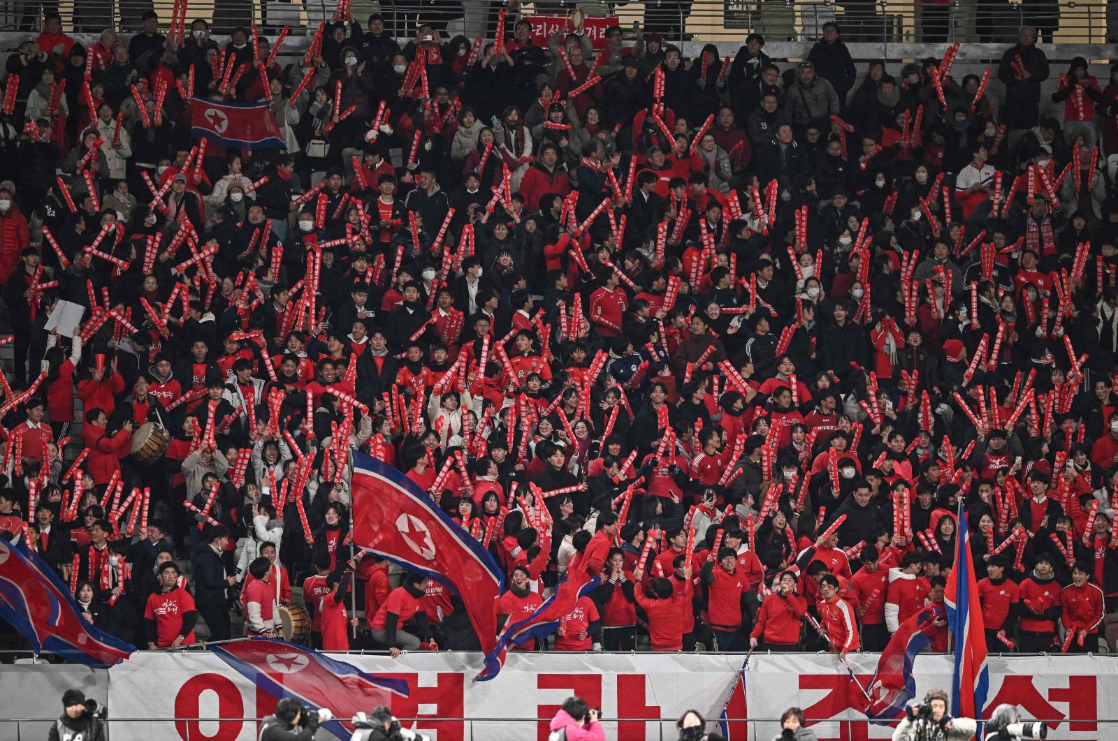 North Korean fans cheer after their team scored their first goal in the second half during the 2024 Olympic qualifying women's match between Japan and North Korea, National Stadium, Tokyo, Japan, Feb. 28, 2024. (AFP Photo)