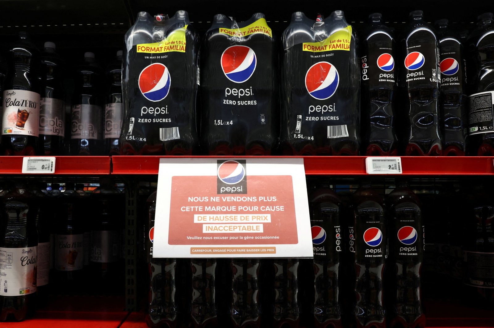 A sign reading "We are no longer selling this brand due to unacceptable price increases. We apologize for the inconvenience caused" is seen on a shelf for PepsiCo product Pepsi at a Carrefour hypermarket, Paris, France, Jan. 4, 2024. (Reuters Photo)