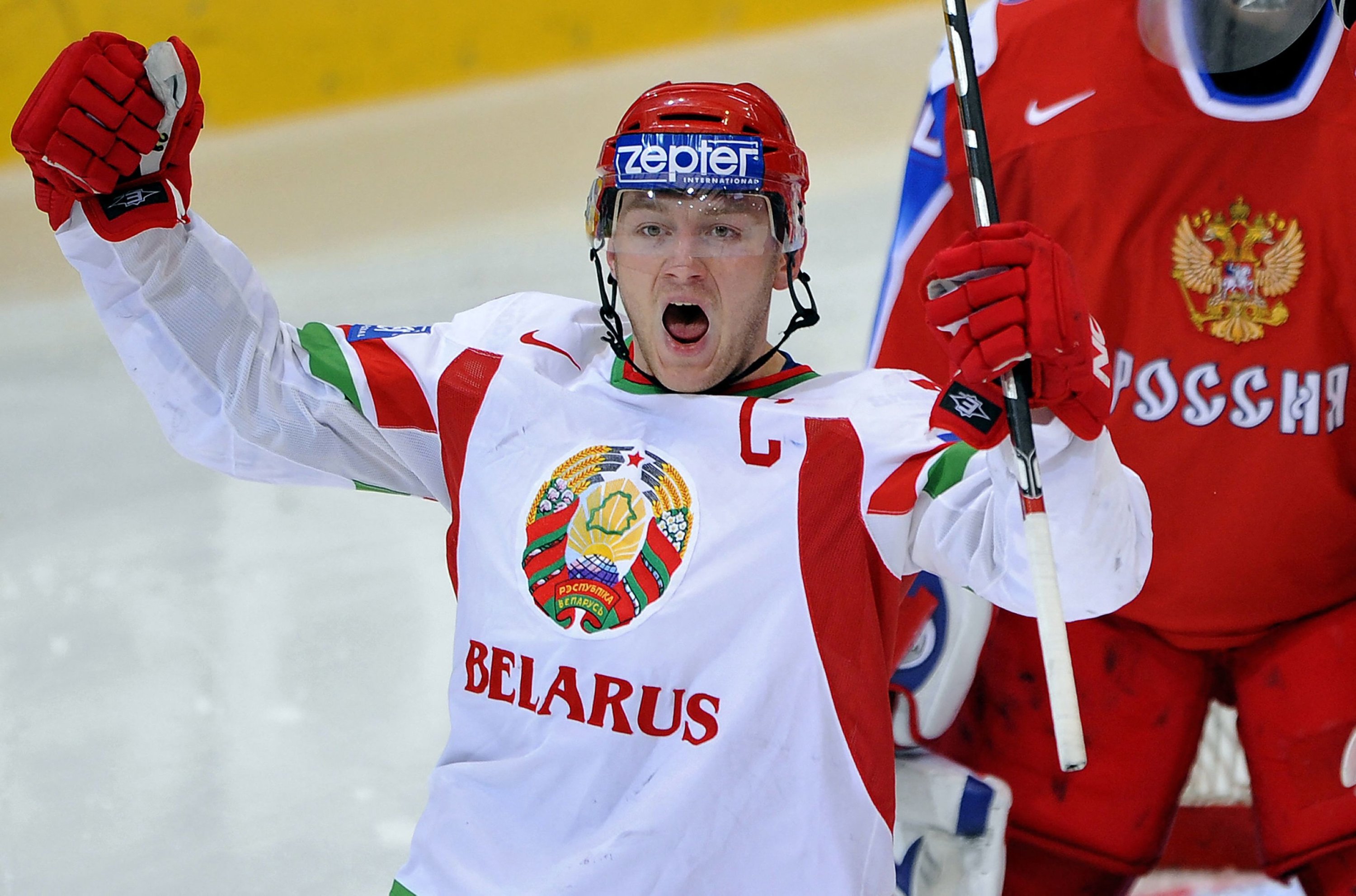 320496 Belarus Konstantin Koltsov celebrates his team's first goal in front of Russian goalkeeper Ilya Bryzgalov during their quarter-final game at the 2009 IIHF Ice Hockey World Championships, Bern, Switzerland, May 6, 2009. (AFP Photo)