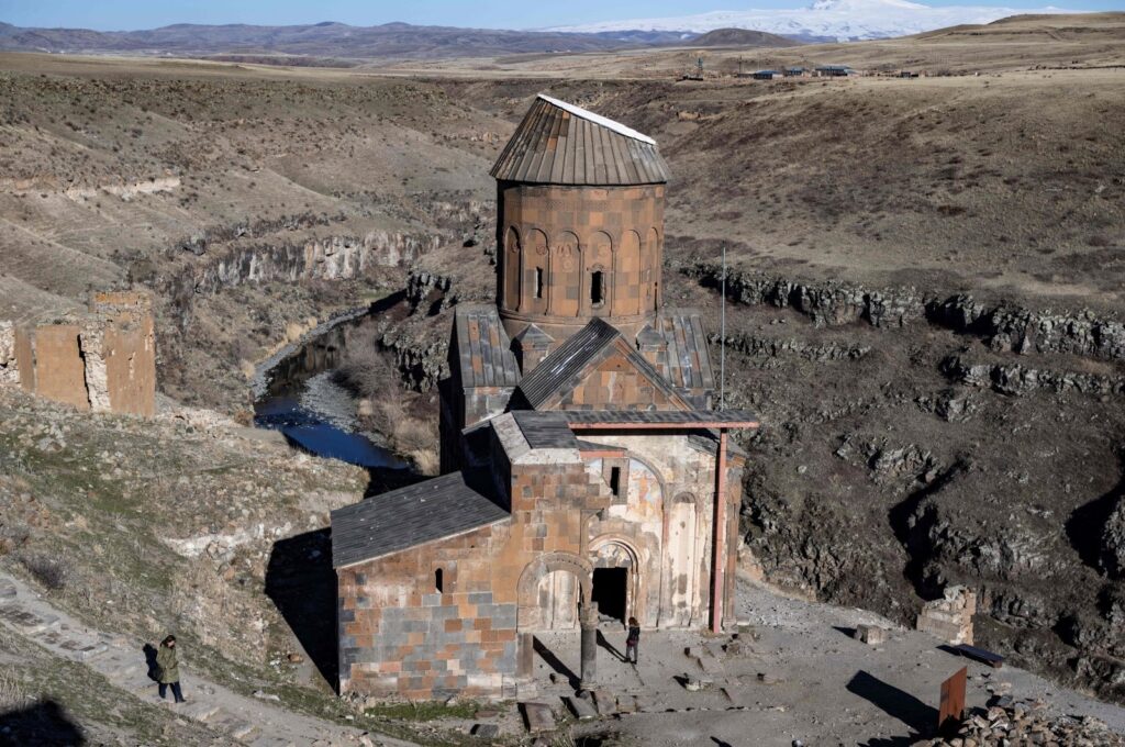 A woman walks near Tigran Honents Church in the Ani ruins near Kars, Türkiye, Feb. 28, 2024. (AFP Photo)