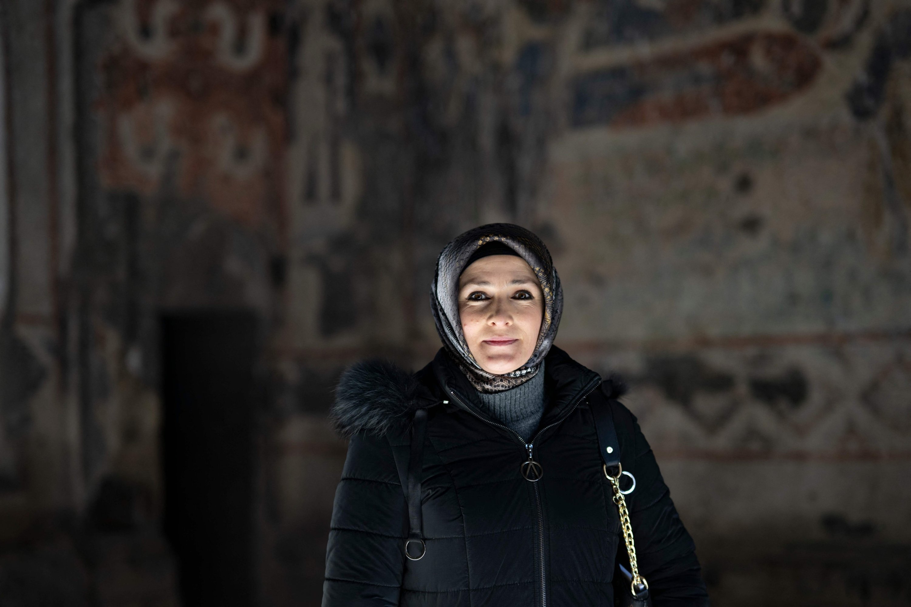 320539 Gonca Pabuçcu, deputy head of the digging team, poses in front of Tigran Honents Church, near Kars, Türkiye, Feb. 28, 2024. (AFP Photo)