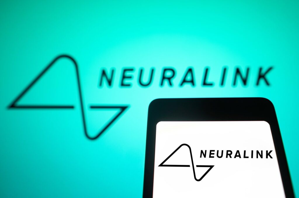 In this photo illustration, the Neuralink logo is displayed on a smartphone screen and in the background, Feb. 4, 2024. (Reuters File Photo)