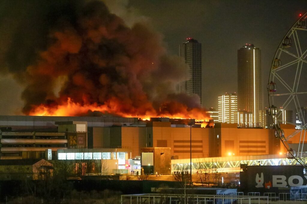 A massive blaze is seen over the Crocus City Hall on the western edge of Moscow, Russia, Friday, March 22, 2024. (Moscow News Agency via AP)