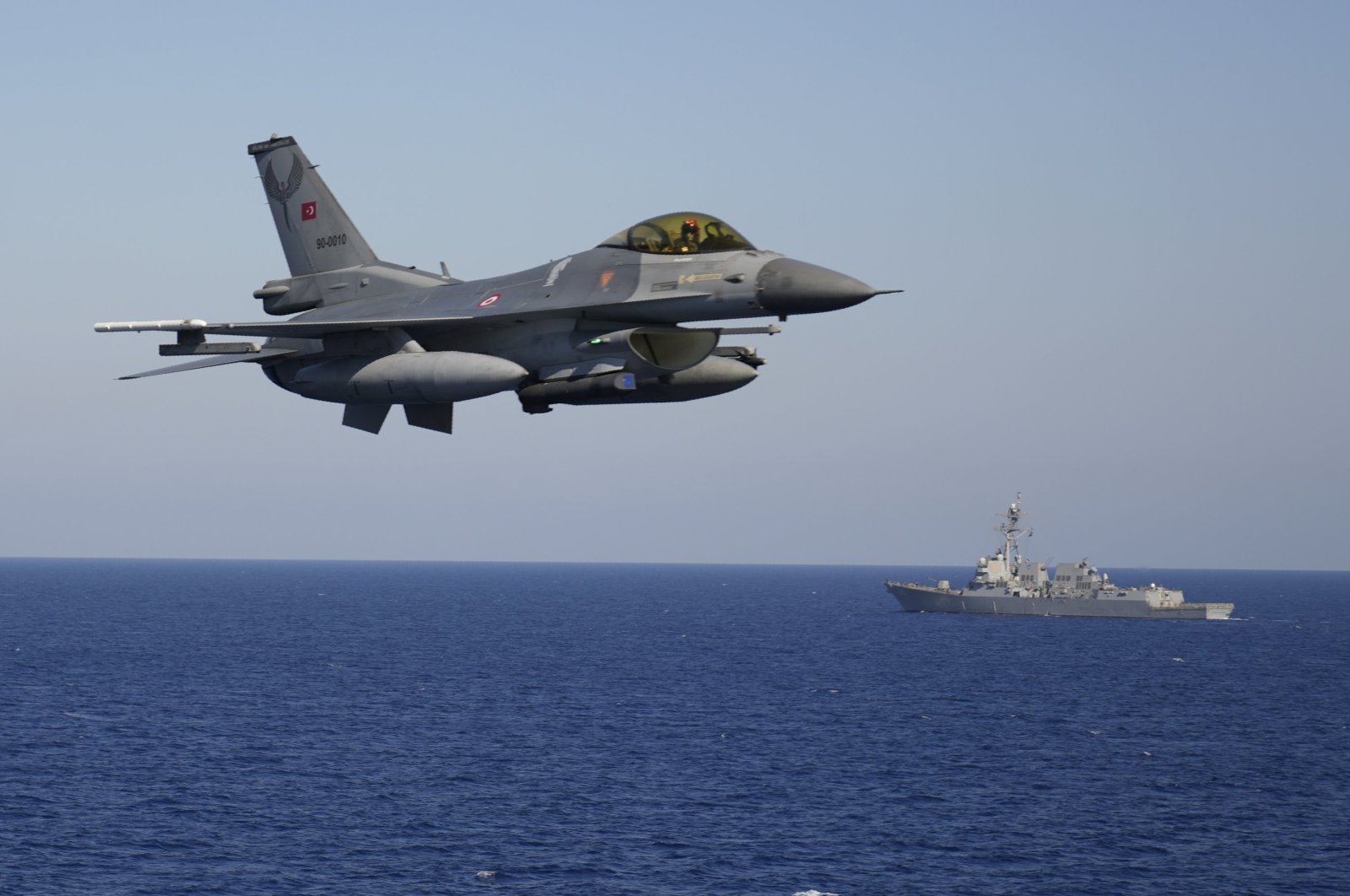 A Turkish F-16 fighter flies over naval ships during an annual NATO naval exercise on Türkiye's western coast on the Mediterranean, Sept. 15, 2022. (AP File Photo)