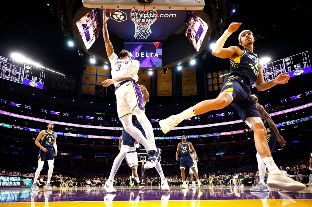 Los Angeles Lakers' Anthony Davis (L) takes a shot against Indiana Pacers' Andrew Nembhard in the first half at Crypto.com Arena, Los Angeles, U.S., March 24, 2024. (AFP Photo)