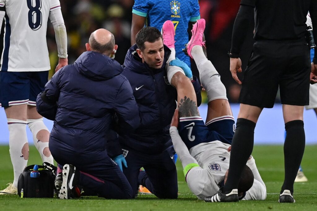 England's defender Kyle Walker (R) is treated by medical staff after picking up an injury during the international friendly football match between England and Brazil at Wembley Stadium, London, U.K., March 23, 2024. (AFP Photo)