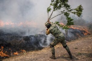 A soldier works to contain wildfires in Nogales, in Veracruz state, Mexico, March 25, 2024. (AP Photo)