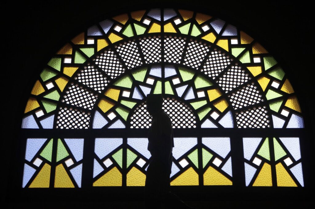 A man walks past stained glass windows inside the Gaddafi National mosque after Friday prayers in the capital of Kampala, Uganda, Oct. 21, 2011. (Reuters Photo)