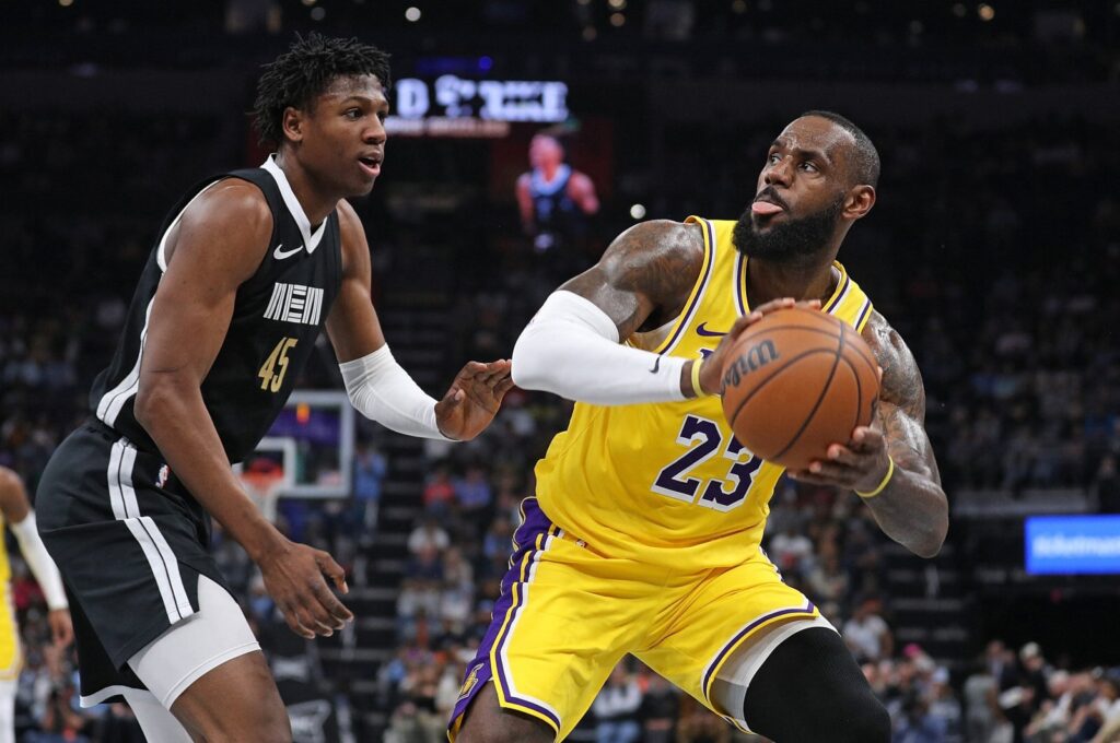 Los Angeles Lakers' LeBron James (R) handles the ball against Memphis Grizzlies' GG Jackson during the first half at FedExForum, Memphis, Tennessee, U.S., March 27, 2024. (AFP Photo)