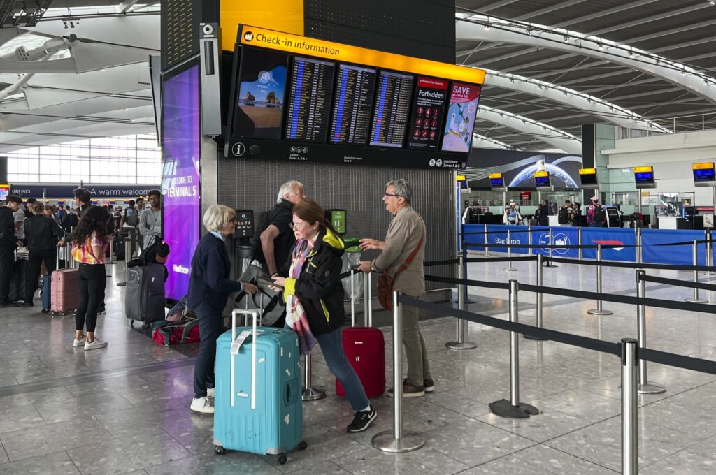 Passengers look at the departures board at Heathrow Airport, London, U.K., Aug. 28, 2023. (AP Photo)