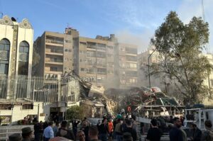 Emergency and security personnel gather at the site of strikes which hit a building adjacent to the Iranian embassy in Syria's capital Damascus, on April 1, 2024. (AFP Photo)