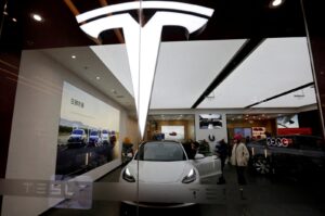Visitors check a Tesla Model 3 car next to a Model Y displayed at a showroom of the U.S. electric vehicle maker, Beijing, China, Feb. 4, 2023. (Reuters Photo)