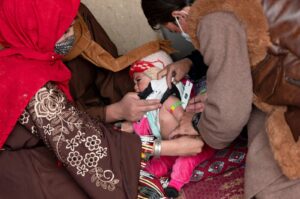 A member of the Community Health Workers (CHW) examines an Afghan child to assess malnutrition at a health post in Badakhshan, Afghanistan, Feb. 25, 2024. (AFP Photo)