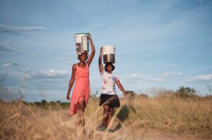 Residents of Pumula East township walk home after fetching water from a well, as temperatures soar during an El Nino-related heatwave and drought, Bulawayo, Zimbabwe, March 7, 2024. (Reuters Photo)