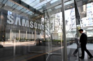 A man walks past the Samsung logo displayed on a glass door at the company's Seocho building in Seoul, South Korea, April 5, 2024. (AFP Photo)