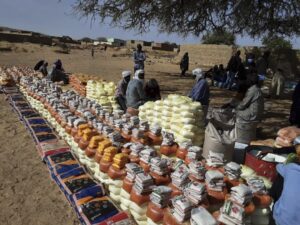 This handout photo provided by World Relief shows emergency food being distributed by the World Food Program (WFP) and World Relief in Kulbus, West Darfur, Sudan, end of March 2024. (World Relief via AP)
